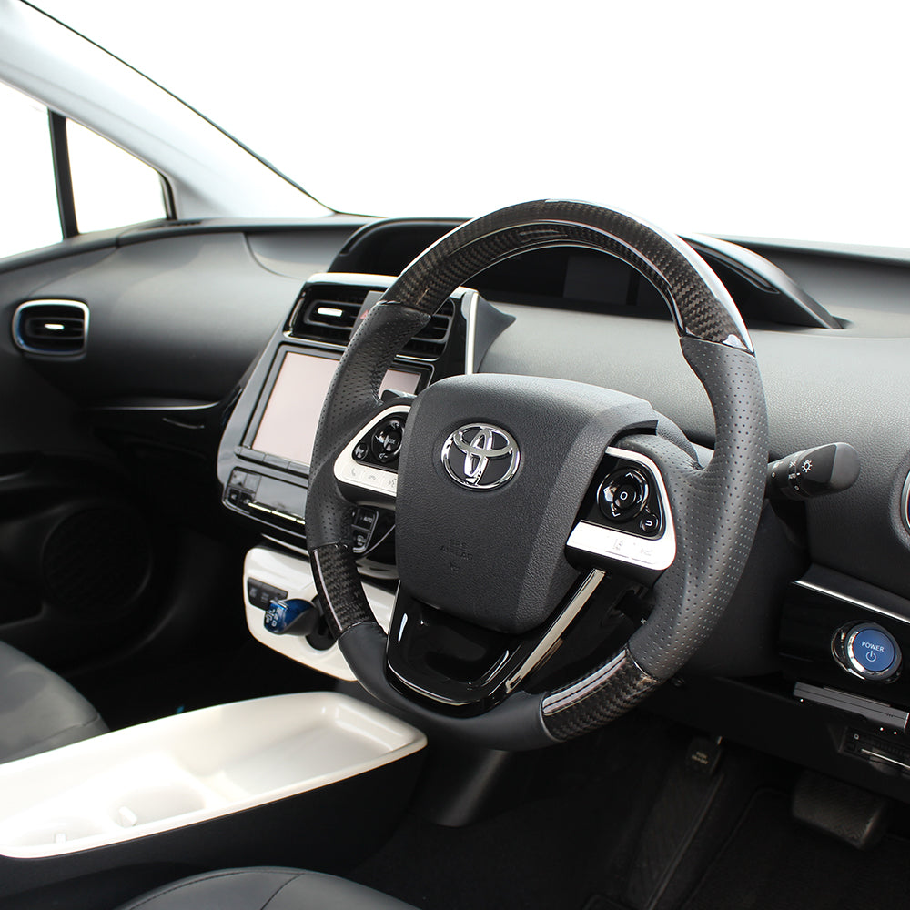 REAL PREMIUM SERIES SET BLACK CARBON STEERING + PIANO BLACK UNDER PAD BLACK EURO STITCH STEERING WHEEL FOR TOYOTA PRIUS 50  50P-BKC-BK-PBP